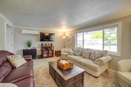 a living room with a couch and a table at Dog-Friendly Idaho Falls Vacation Rental with Yard! in Idaho Falls