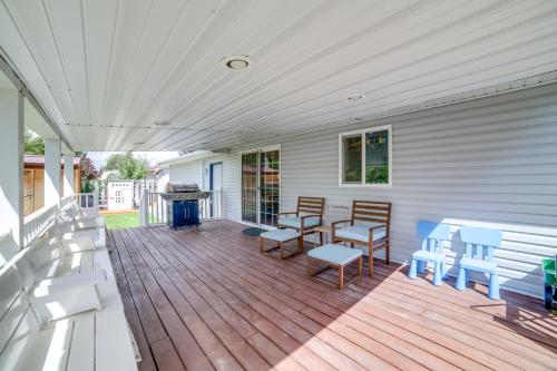 a porch with benches and a grill on a house at Dog-Friendly Idaho Falls Vacation Rental with Yard! in Idaho Falls