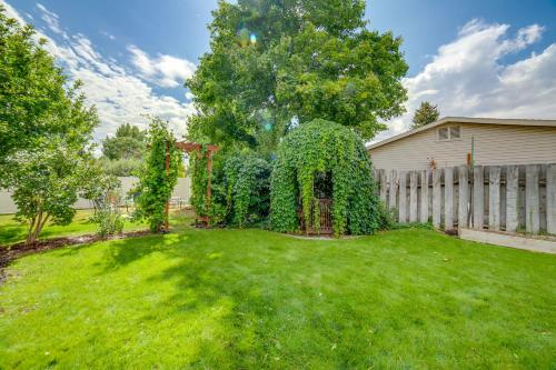 a yard with a fence and green grass at Dog-Friendly Idaho Falls Vacation Rental with Yard! in Idaho Falls