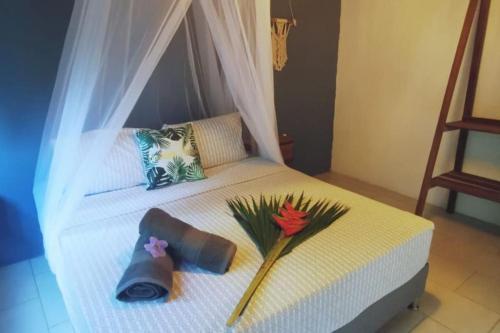 a bedroom with a bed with a flower on it at Casa Matilda - Palomino in Palomino