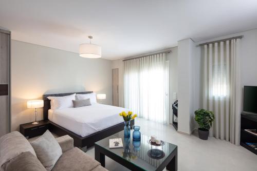 a bedroom with a bed and a living room with a couch at Piccadilly House in Arta