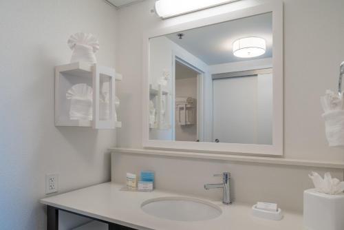a white bathroom with a sink and a mirror at Hampton Inn & Suites Valley Forge/Oaks in Phoenixville