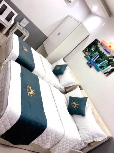 a bedroom with a bed with a tie on it at Holiday Hotel 2 in An Khê