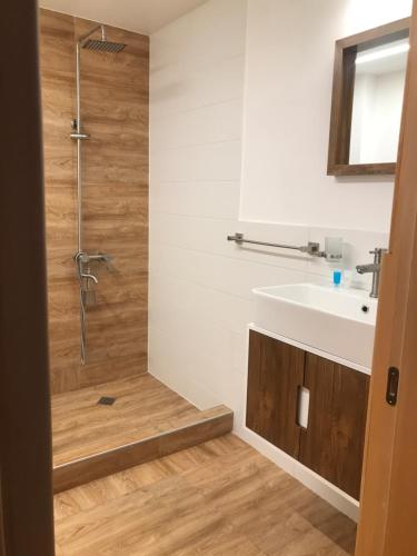 a bathroom with a shower and a sink at Boutique hotel mestia in Mestia