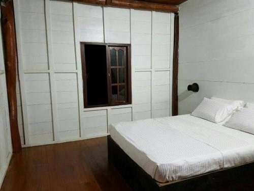 a bedroom with a bed and a window at Milla Resort in Buttala