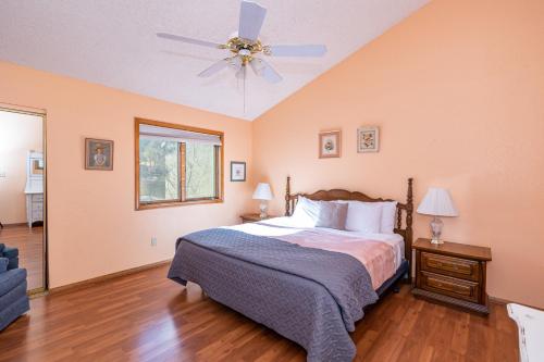a bedroom with a bed and a ceiling fan at Bear Paw Condo in Flagstaff