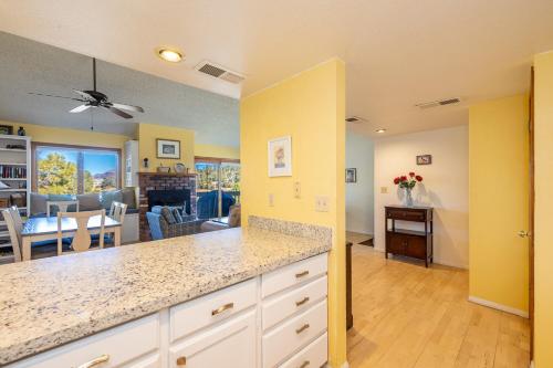 a kitchen and living room with yellow walls at Bear Paw Condo in Flagstaff