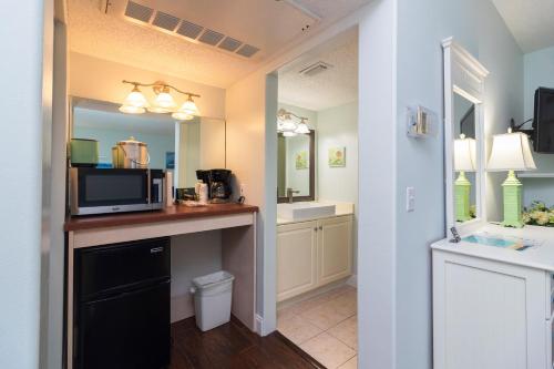 a bathroom with a microwave on a counter with a sink at Inn at Camachee Harbor Garden View 15 in Saint Augustine