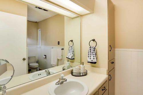 a bathroom with a sink and a large mirror at San Antonio Home Near Nature, Parks and Trails in San Antonio