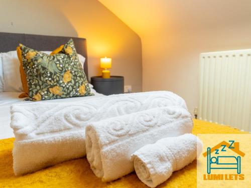 ein Schlafzimmer mit einem Bett mit Handtüchern darauf in der Unterkunft 2BR Home In Barrow-in-Furness Sleeps 8 close to BAE Systems, Hospital, Lakes in Barrow in Furness