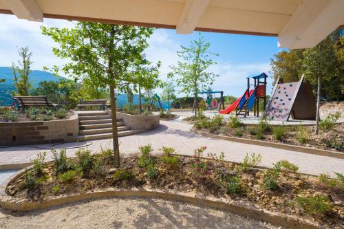 a park with a playground with a slide at Hotel La Perla Del Golfo in Procchio