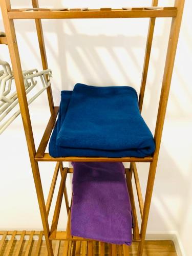 a wooden chair with a blue cushion on it at 4BR M Vertica near Sunway Velocity Cheras IKEA MRT TRX KLCC Pavilion in Kuala Lumpur