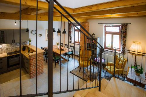 a kitchen and dining room with a staircase in a house at Chalupa Mahouš 19 in Mahouš