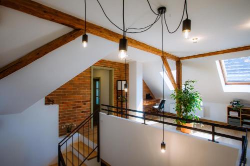a staircase in a loft with wooden beams at Chalupa Mahouš 19 in Mahouš