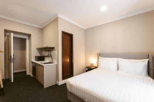 a hotel room with a bed and a microwave at Salve in Tbilisi City