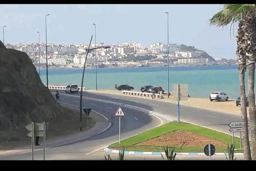 a winding road next to a beach with a city at soleil d'chamalo in Fnidek