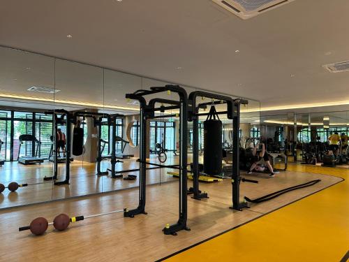 a gym with rows of exercise equipment on the floor at 4BR M Vertica near Sunway Velocity Cheras IKEA MRT TRX KLCC Pavilion in Kuala Lumpur