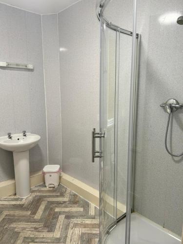 a bathroom with a shower and a sink at Adina Hotel in Blackpool