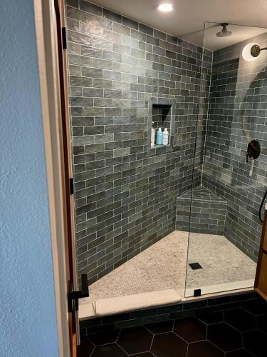 a shower with a glass door in a bathroom at NEW Modern apt w/pool & hot tub in nature in Thousand Oaks