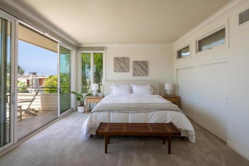 a bedroom with a large bed and a balcony at Ocean View Del Mar Beach Home w Jacuzzi in San Diego