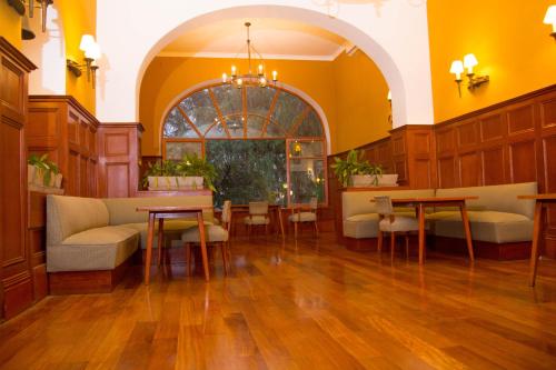 a lobby with tables and chairs in a building at DM Hoteles Mossone - Ica in Ica