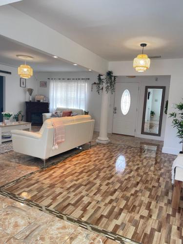 a living room with a couch and wooden floor at House of the statue of Adrianne in Tampa