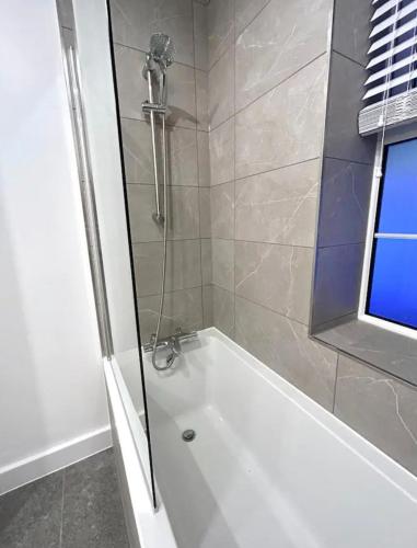 a bathroom with a shower with a white bath tub at 2 Bedroom Luxury Appartment in Finchley