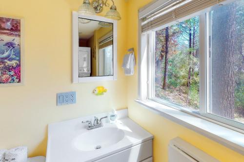 a bathroom with a sink and a window at Alford Family Lodge in Bass Lake