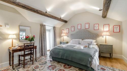 a bedroom with a bed and a desk and a table at Griffedale in Brassington