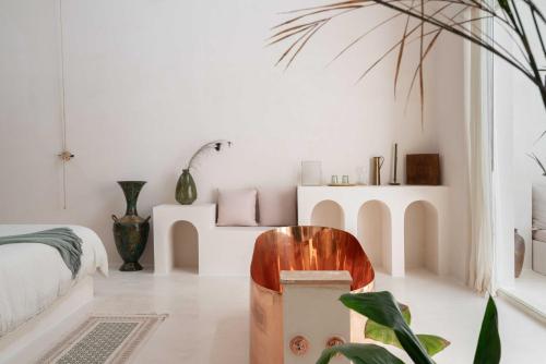a room with a bed and a chair in it at Anat Tantric Boutique Hotel in Tulum