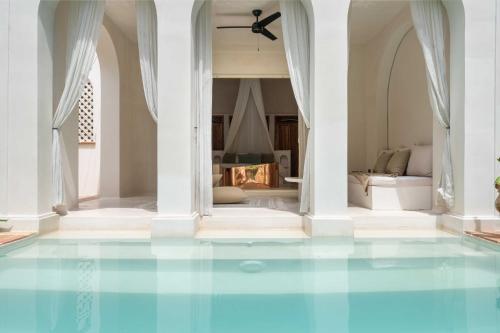 a room with a blue floor and a fireplace at Anat Tantric Boutique Hotel in Tulum