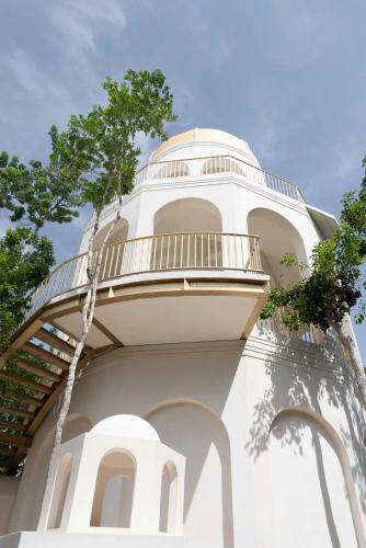 a building with a spiral staircase on top of it at Anat Tantric Boutique Hotel in Tulum
