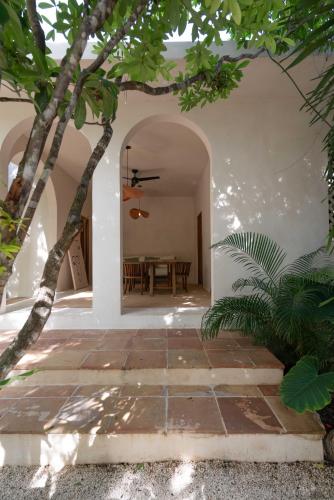 a courtyard with a table in a house at Anat Tantric Boutique Hotel in Tulum