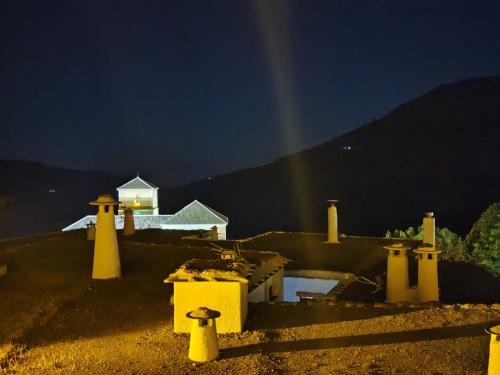 a rainbow in the sky over a house at night at Casa Las Alacenas, Bubión (La Alpujarra, Granada) in Bubión