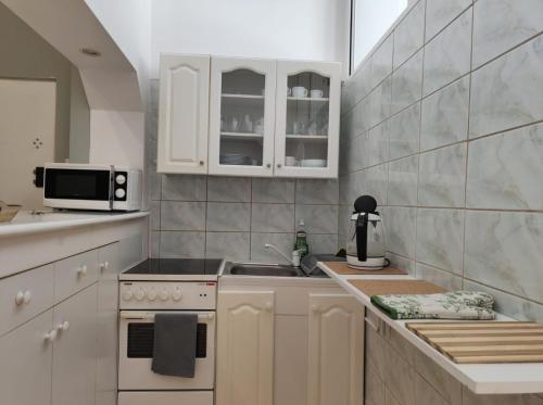 a kitchen with white cabinets and a sink at Beach 1 minuta, Grand Hotel, Sheraton, molo, Best location in Sopot