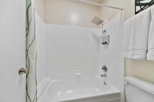 a white bathroom with a shower and a sink at Beverly Hills Gem 1 BR Apt with Parking 218 in Los Angeles