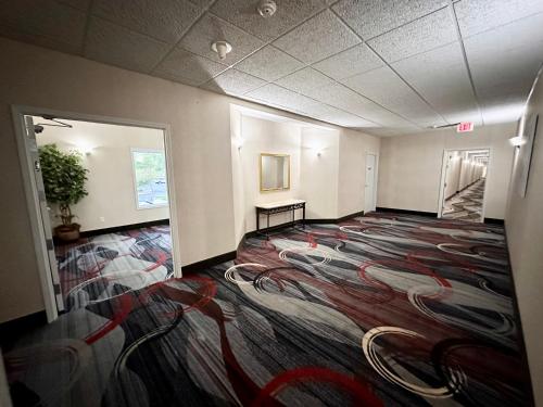 a large room with a large rug on the floor at MainStay Suites Madison Airport in Madison