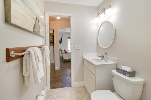 a bathroom with a toilet and a sink and a mirror at Charming Apartment in Downtown Georgetown! in Georgetown