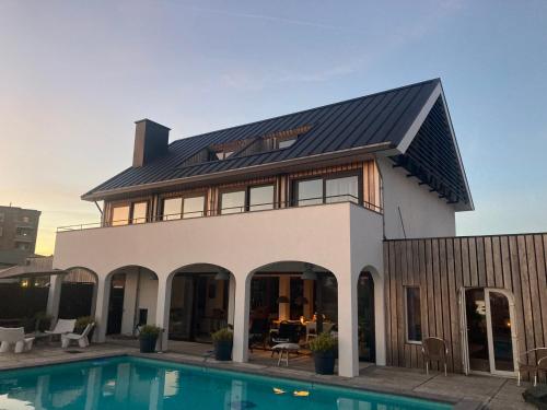 a house with a swimming pool in front of it at Villa Zandvoort in Zandvoort