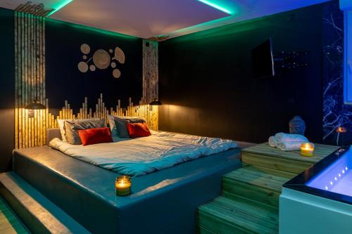 a bedroom with a bed with blue lights on it at UNE PARENTHESE ARDENNAISE in Charleville-Mézières