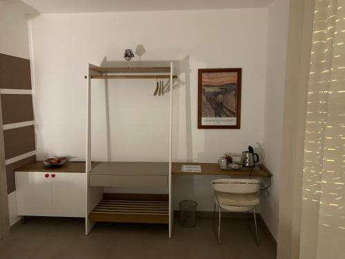 a room with a desk and a shelf and a table at La Casa di Toni in Pescara