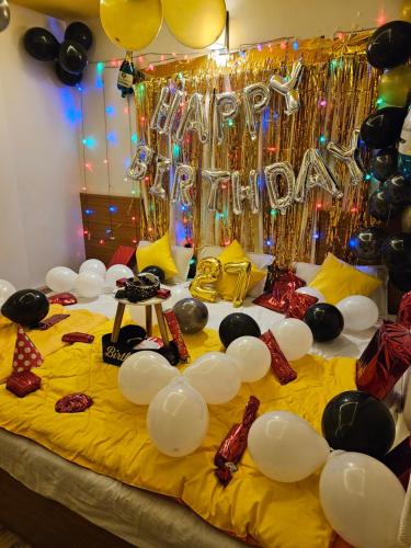 a bed with a bunch of decorations on it at Hotel Sai Dakshina Inn & The Fern Restaurant in Shirdi