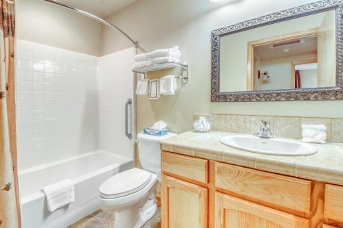 a bathroom with a toilet and a sink and a mirror at Icicle Village Resort 401 Aspen Abode in Leavenworth