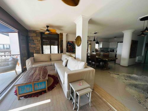 a living room with a couch and a table at Deniz manzarali tas villa in Bodrum City