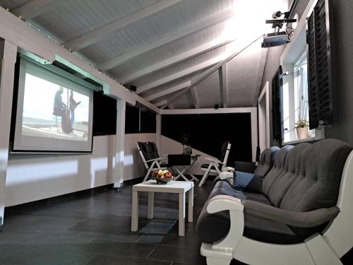 a living room with a couch and a screen at Jakop Hof in Krapinske Toplice