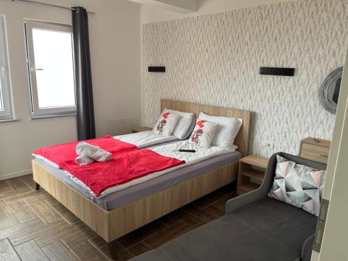 a bedroom with a bed with a red blanket at Vila Vista Magica Radozda in Struga