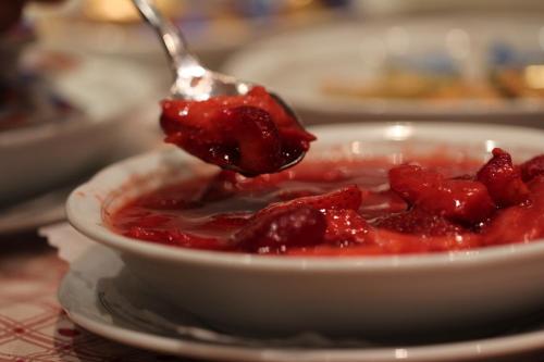 a spoonful of strawberry jam on a bowl of food at Gasthaus Hotel zum Kreuz in Stetten am Kalten Markt