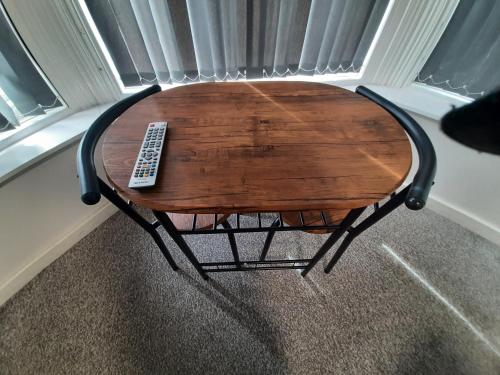 a table with a remote control sitting on top of it at Exclusive Self-contained flat in Middlesbrough in Middlesbrough