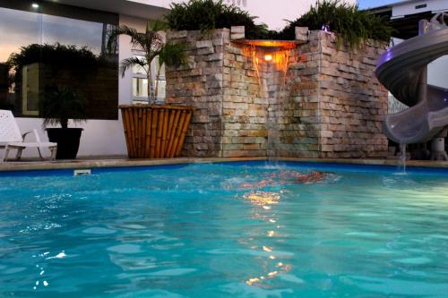 a swimming pool with a slide in a house at Terramar Hoteles in Crucita