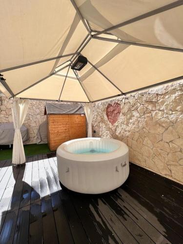 a large bath tub in a tent with a room at Lady Luxury Apartment in Bari